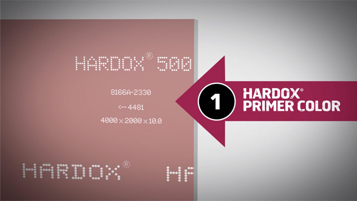 Genuine Hardox® wear plate, with product markings and its tell-tale red primer color.