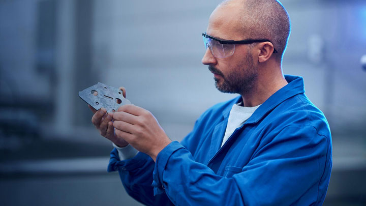 Scientist holding a piece of steel