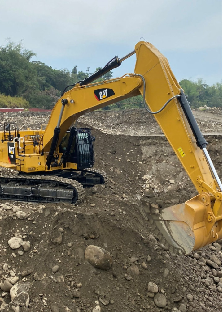 A yellow earthmoving attachment made in Hardox wear plate digging in the dirt