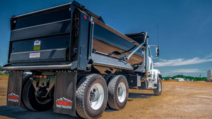 A black dump truck with trailer body made in Hardox® 500 Tuf.   