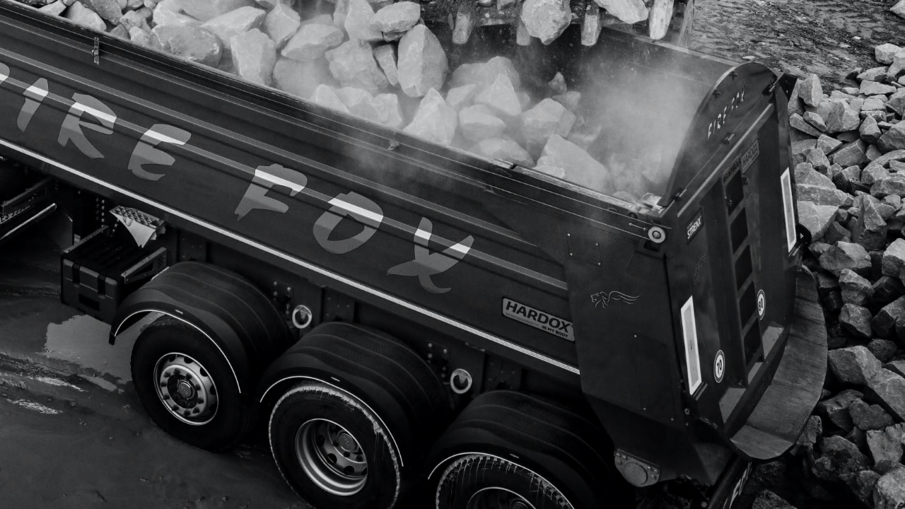 Black and white photo of the Firefox dumper body loaded with rocks, made in Hardox® 500 Tuf wear plate.