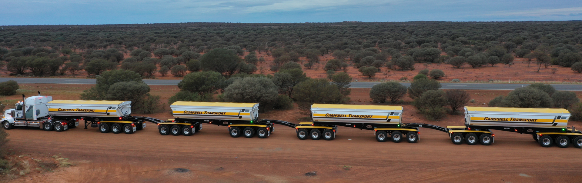 A road train of side dump trailers in Australia