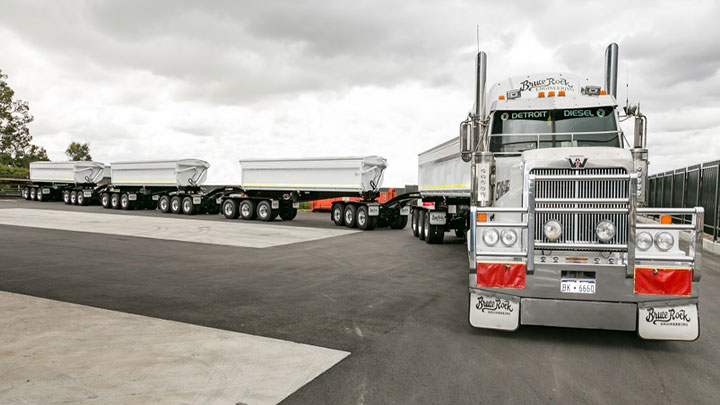 A road train with white-painted bodies made in strong and tough Hardox® wear plate.