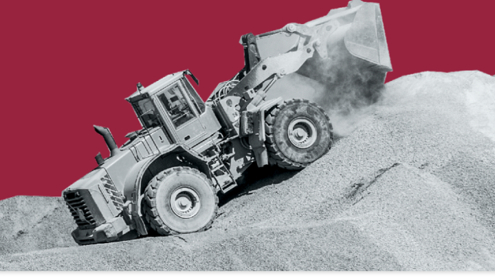 A wheel loader in a quarry shown on a red background. 