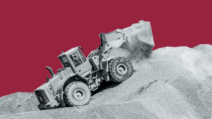 A truck heading down a steep hill in a quarry.