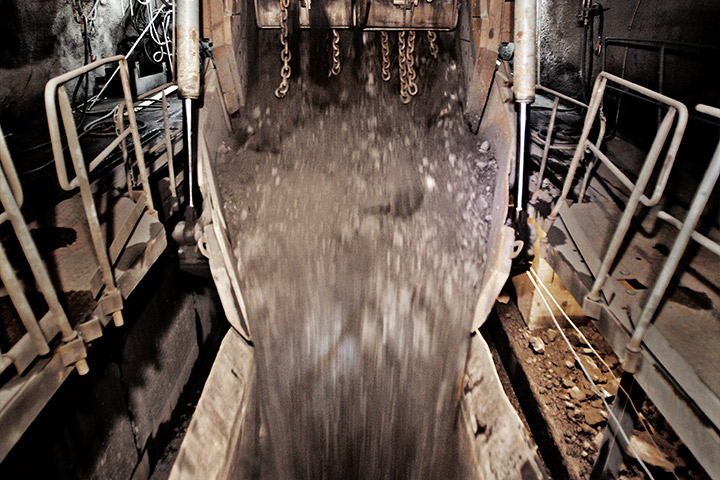 Giant bucket in an underground mine spilling out its contents