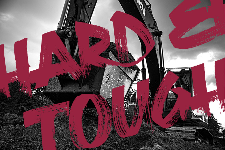 The message „Hard and Tough“ over a mining excavator