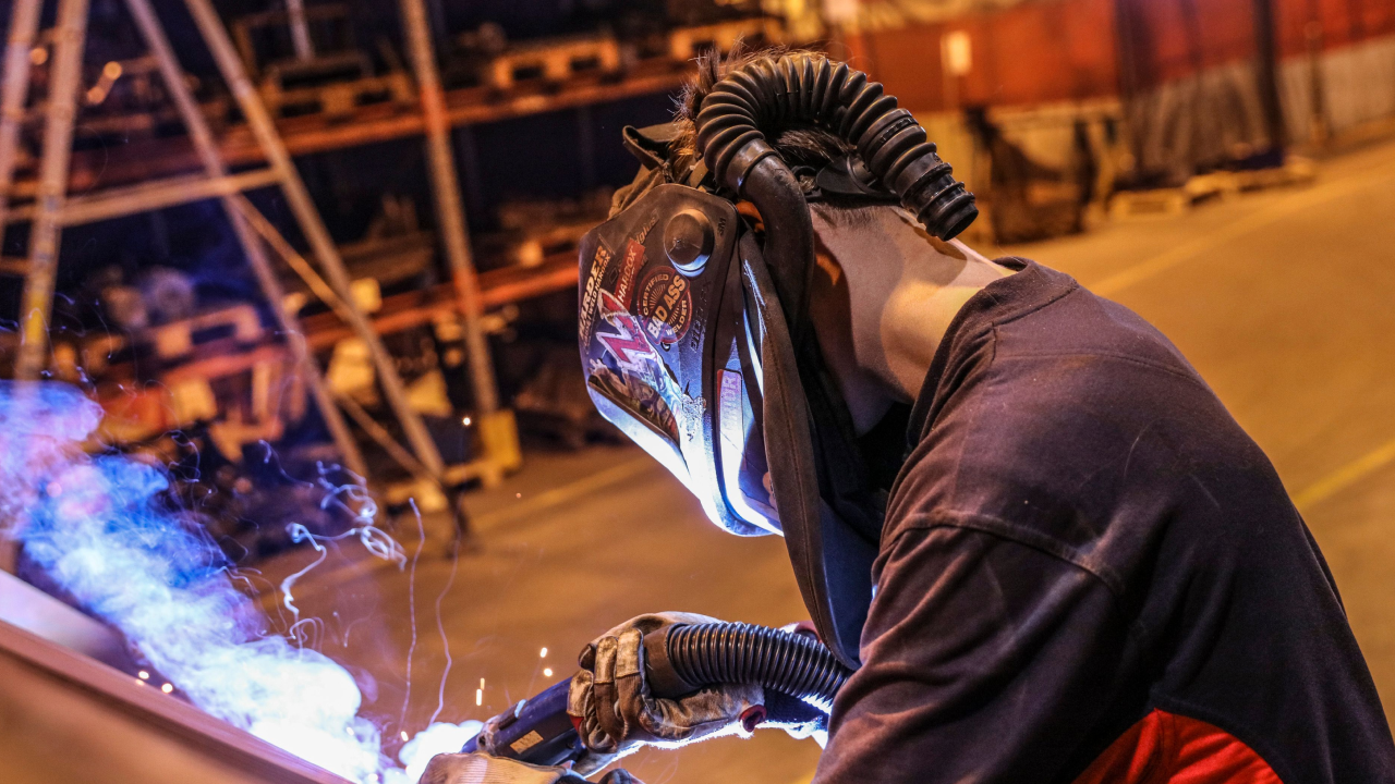 Close-up of a welder welding the steel Hardox Extreme.