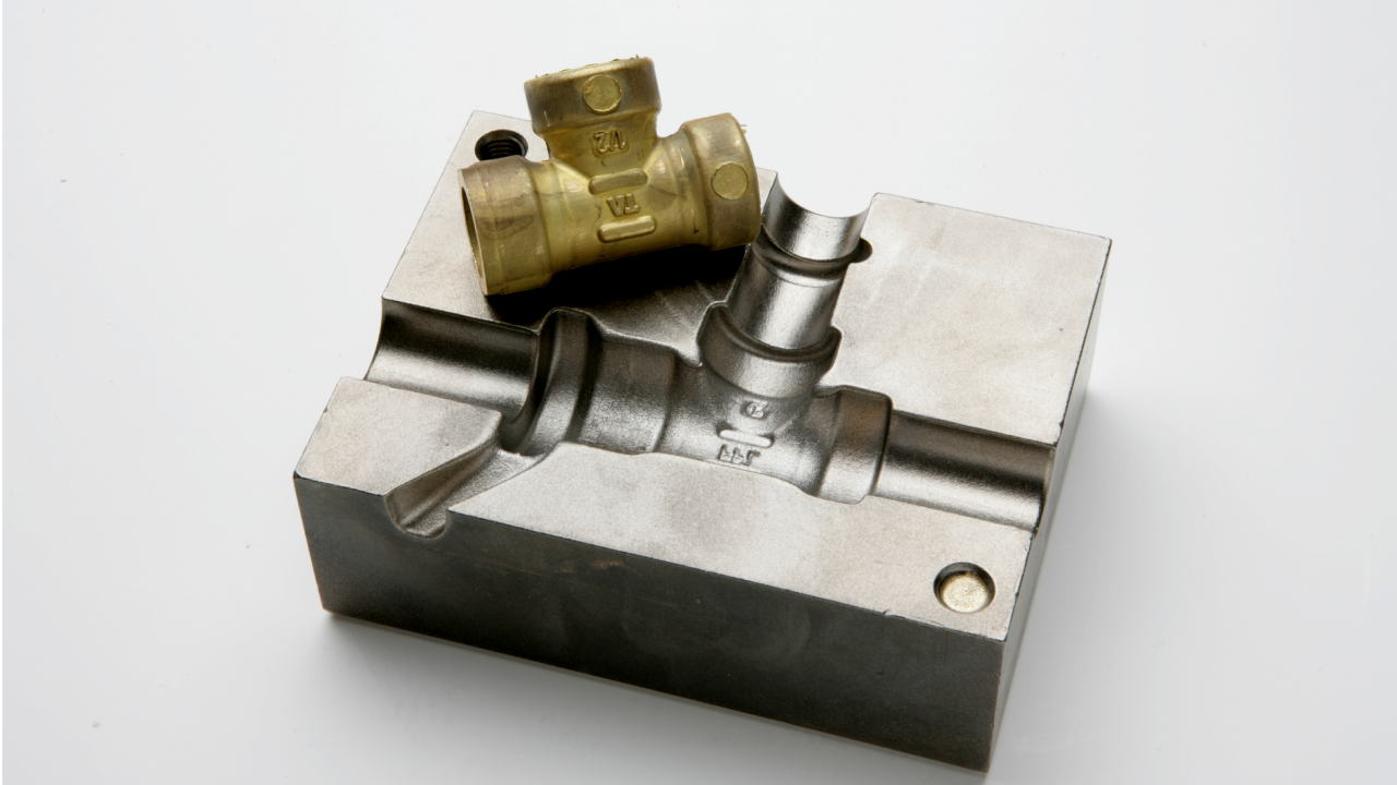 A mold in tool steel with a cast coupling in brass