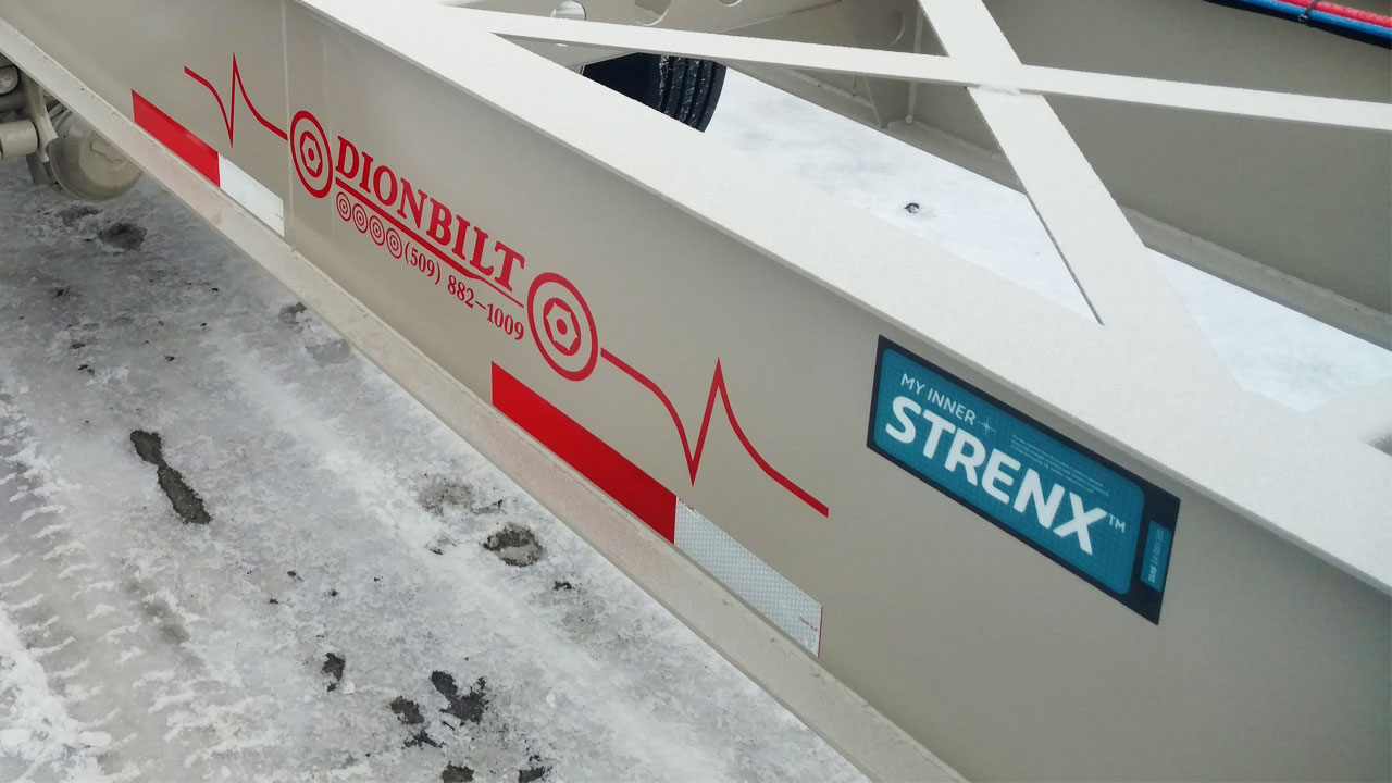 Close-up photo of a white trailer chassis beam with My Inner Strenx sign