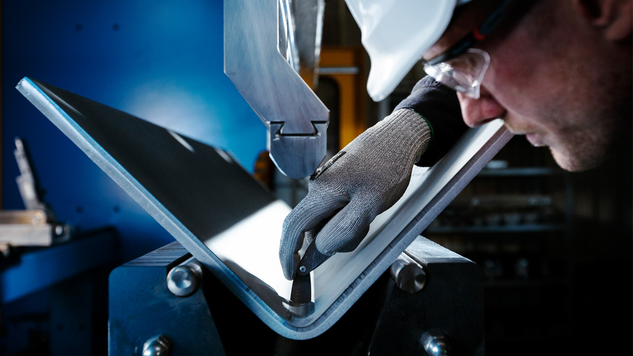 Person inspecting bending of a Strenx® steel plate.